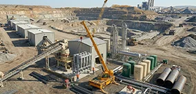 Broderson IC-100 carry deck crane supporting heavy picks across a large industrial site.