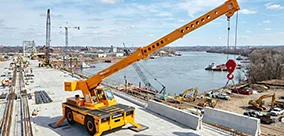 Broderson IC-100 carry deck crane set up for heavy picks on a bridge project.