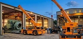 Broderson IC-200 carry deck cranes supporting heavy maintenance lifts with controlled positioning.
