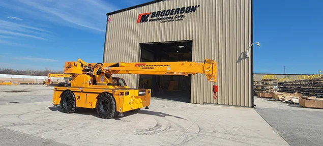 Broderson Carry Deck Cranes positioned for work, with the boom stowed and hook ready.
