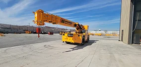 Broderson IC-400 Carry Deck Cranes staged outside the shop, boom out and hook ready.