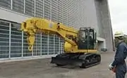 Maeda CC1908S-1 crawler crane positioned beside an industrial building with operator nearby