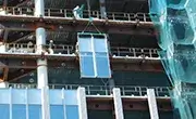 Maeda MC285C spider crane lifting glass panels during building installation work