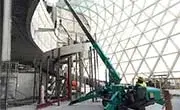 Maeda MC305C mini spider crane working inside a large architectural structure