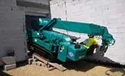 Maeda MC405C compact spider crane positioned in a narrow access area for indoor lifting