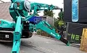 Maeda MC815C spider crane close-up showing articulated boom and stabilizing outriggers