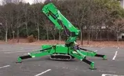 Maeda MK3053 mini spider crane with outriggers fully extended outdoors