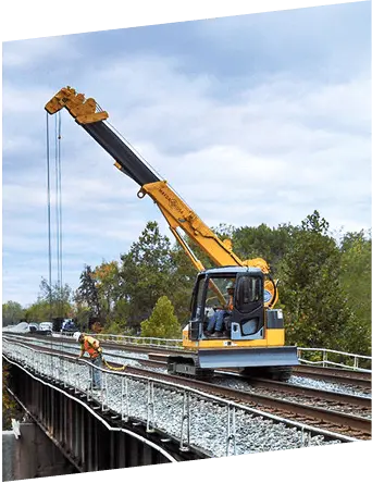 Mini crawler crane performing lifting work on a railway bridge