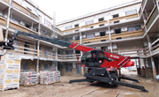 Magni RTH Telehandler lifting heavy load on construction site