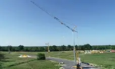 Potain EVY 30-23-4 T tower crane set up on site, delivering long reach for efficient lifting across the work area.