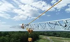 Potain EVY 30-23-4 T at full reach, with the hook block positioned for the next pick.