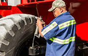 A technician doing tire maintenance on Taylor X800 Heavy Duty Forklift